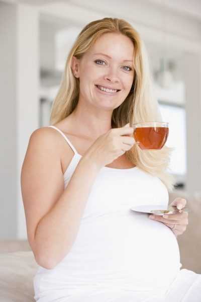 Беременная женщина пьёт чай